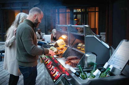 large capacity gas grill cooking multiple dishes simultaneously