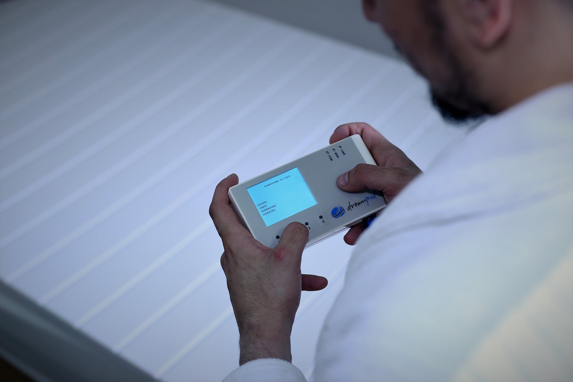 Wired remote control for adjusting temperature and float duration on a Dreampod Home Pro.