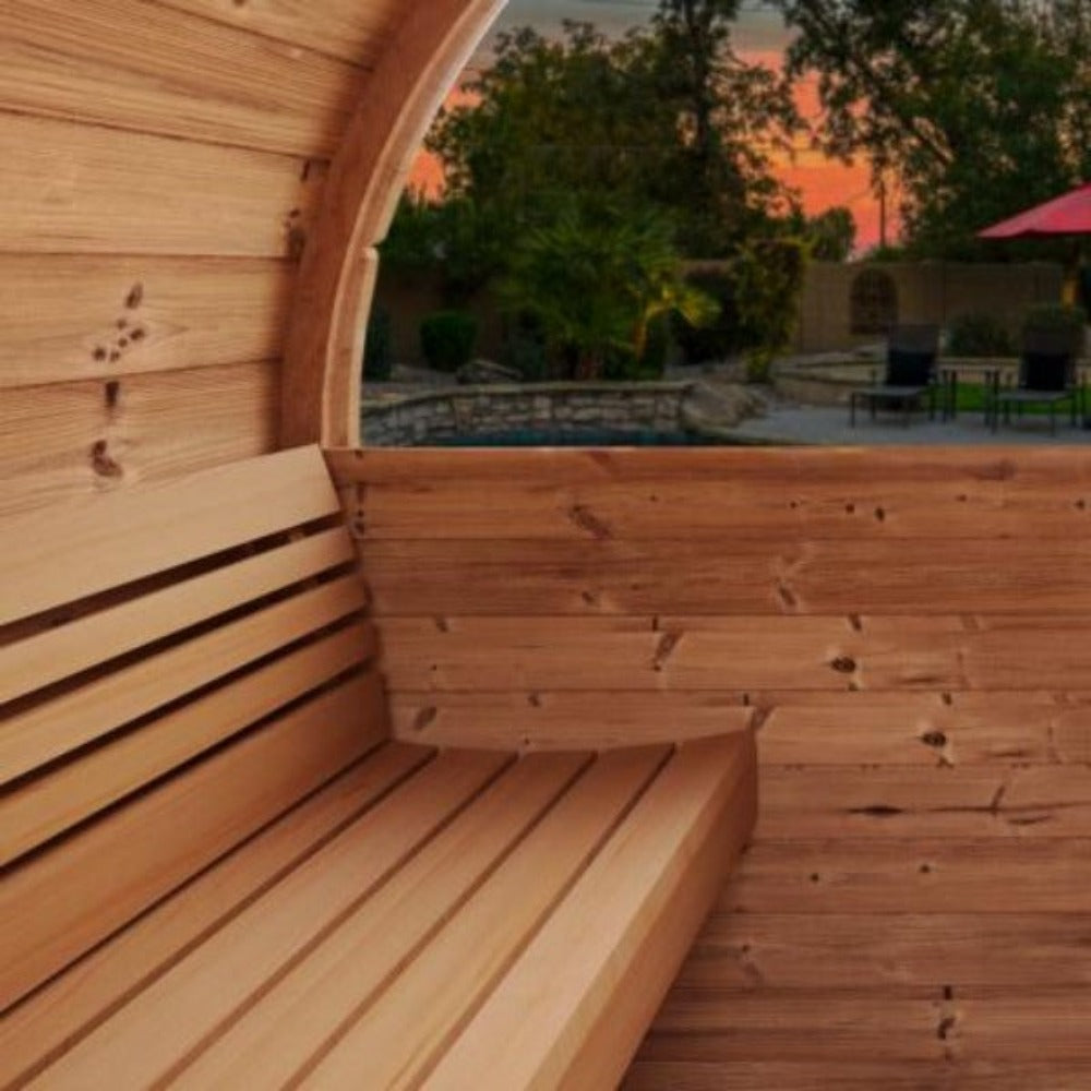 Panoramic half-moon tempered glass window on an outdoor barrel sauna overlooking a backyard.